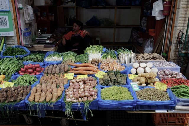 Vegetables sorted into trays on a market table
