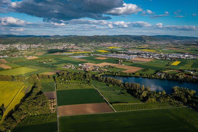Aerial view of farmland bordered by a wide river