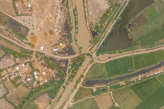 Aerial view of a rural settlement surrounded by irrigated farmland