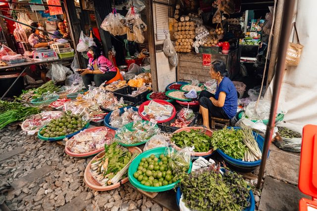 Fresh produce laid out on stalls at a busy market